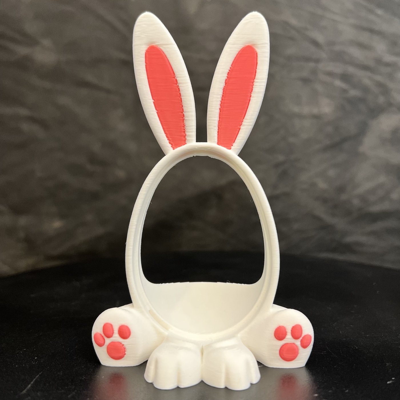 A 3D-printed Easter bunny frame designed to hold a Kinder egg