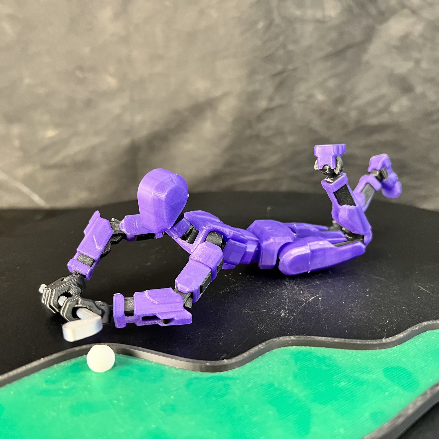 A purple articulated action figure, an example of community-designed 3D printable models